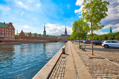 Panoramic view of canal in city against sky