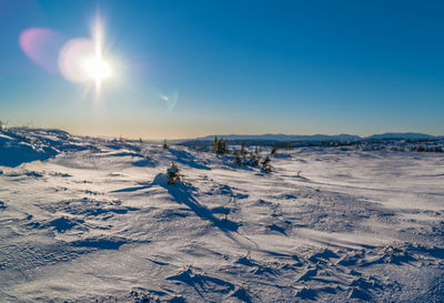 Scenic view of snow covered landscape against sky