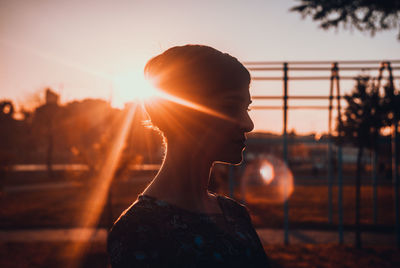 Close-up of young woman at sunset