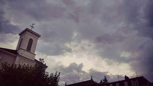 Low angle view of building against cloudy sky