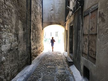 Rear view of woman walking in corridor