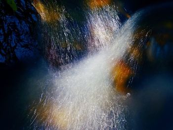 Low angle view of illuminated water at night