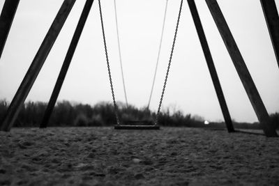Surface level of swing against sky
