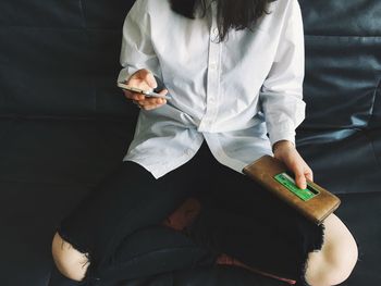 High angle view of woman using mobile phone