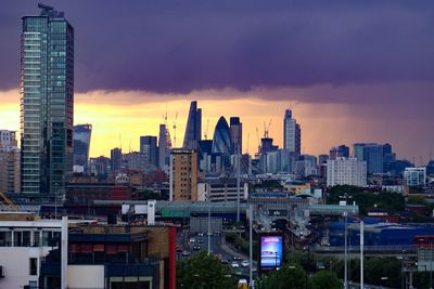 View of cityscape against cloudy sky during sunset