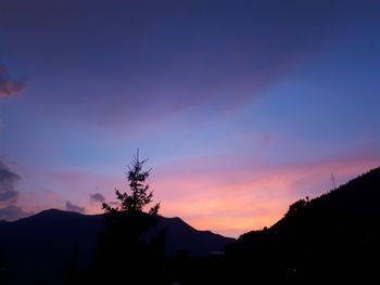 Scenic view of silhouette mountains against sky at sunset