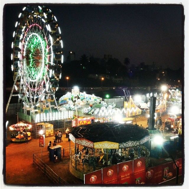 ferris wheel, amusement park ride, amusement park, arts culture and entertainment, illuminated, night, building exterior, city, architecture, built structure, sky, travel destinations, cityscape, motion, capital cities, tourism, city life, transfer print, travel, famous place