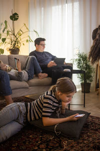 Family is using technologies in living room at smart home