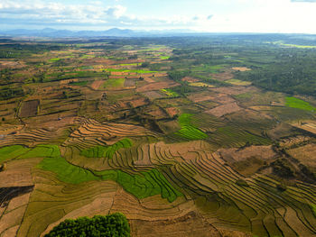 Terraced rice field and farmland in countryside, drone view.