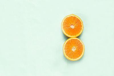 Close-up of orange fruit against white background