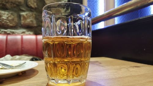 Close-up of beer glass on table