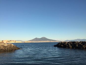 Scenic view of sea against clear blue sky