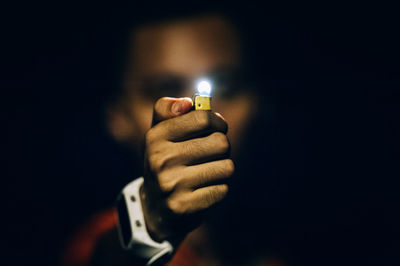 Close-up of hand holding illuminated lights