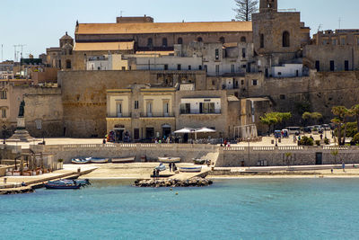 View of swimming pool against buildings in city