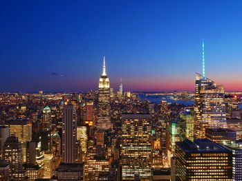 High angle view of city lit up at night