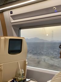 Airplane flying over mountains seen through window