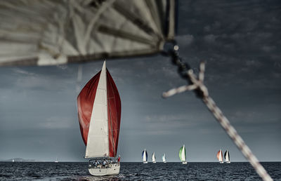 Close-up of sailboat against sea