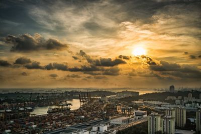 High angle view of city by sea against sky