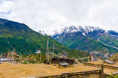 Scenic view of land and mountains against sky