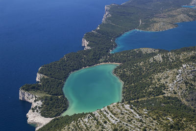 High angle view of rocks on sea shore