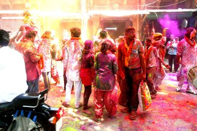 Group of people at illuminated market during night