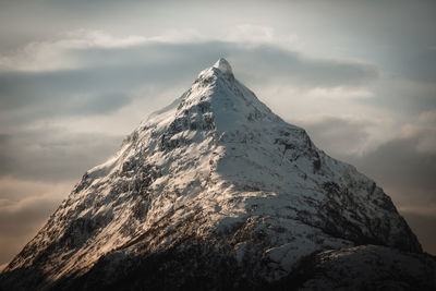 Low angle view of snowcapped mountain against sky