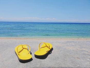 High angle view of shoes on beach against sea