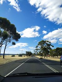 Empty road against sky seen through car windshield