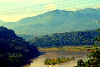 Scenic view of river amidst mountains against sky