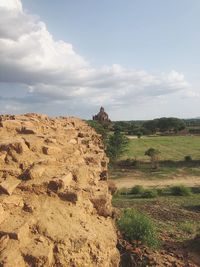 Scenic view of rocks on field against sky