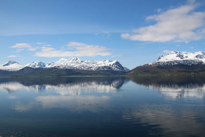 Scenic view of lake and mountains against sky during winter