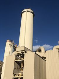 Low angle view of smoke stack against sky