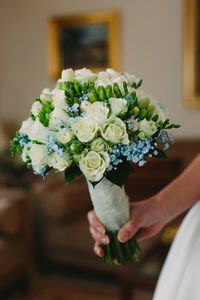 Close-up of woman holding flower bouquet