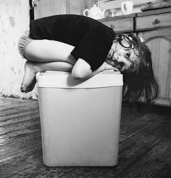 Girl kneeling on seat at home