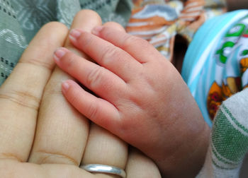 Close-up of couple holding hands