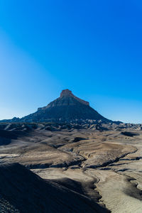 Scenic view of snowcapped mountains against clear blue sky