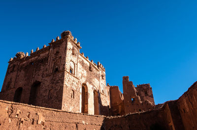 Low angle view of historic building against blue sky