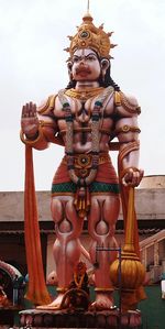 Statue against temple against sky