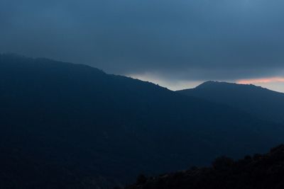 Scenic view of silhouette mountains against sky