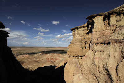 Rock formation on beach against sky