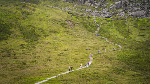 High angle view of people walking on footpath