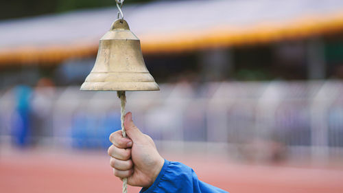 Cropped hand of person ringing bell