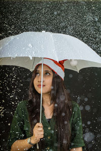 Portrait of young woman in rain