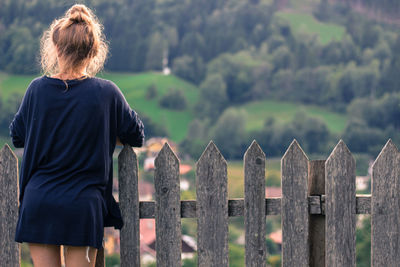 Rear view of woman walking on field