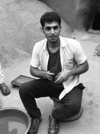 Portrait of young man sitting outdoors