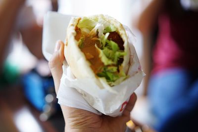 Cropped hand holding shawarma