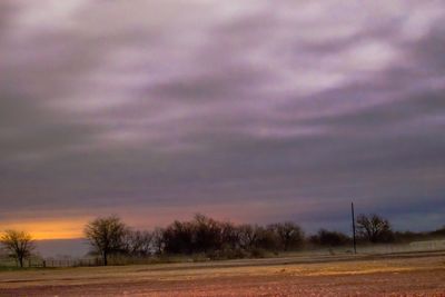 Scenic view of dramatic sky over field