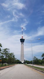 Road by tower against sky