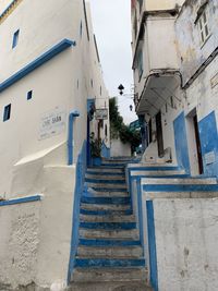 Low angle view of staircase amidst buildings in city