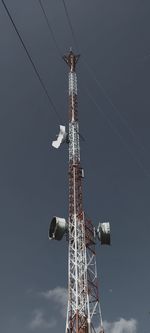 Low angle view of communications tower against sky